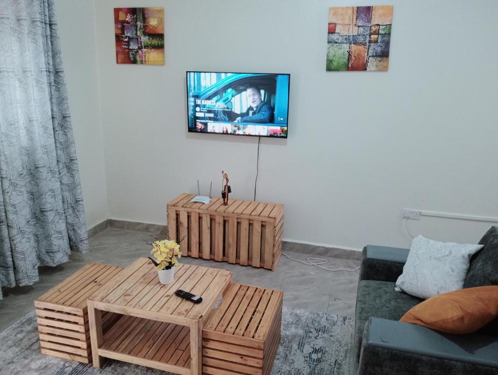 a living room with a couch and a coffee table at Royal Stay in Kira