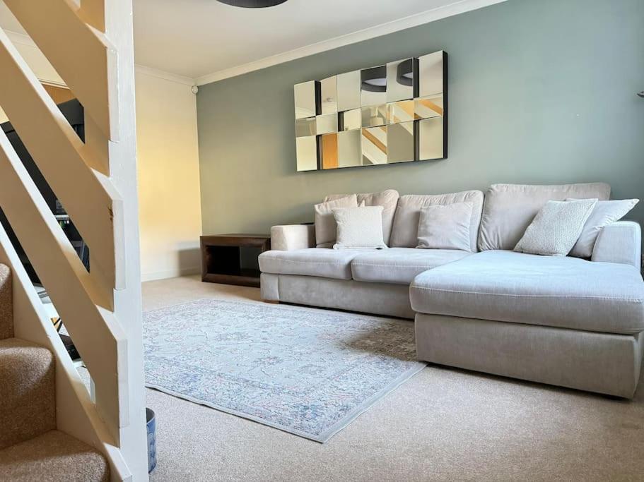 a living room with a couch and a staircase at Heathbrook House in Cardiff