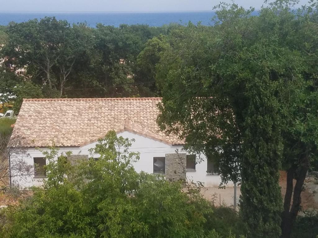 eine Luftansicht eines weißen Hauses mit Bäumen in der Unterkunft Villa neuve à 900 m de la plage in Santa-Lucia-di-Moriani
