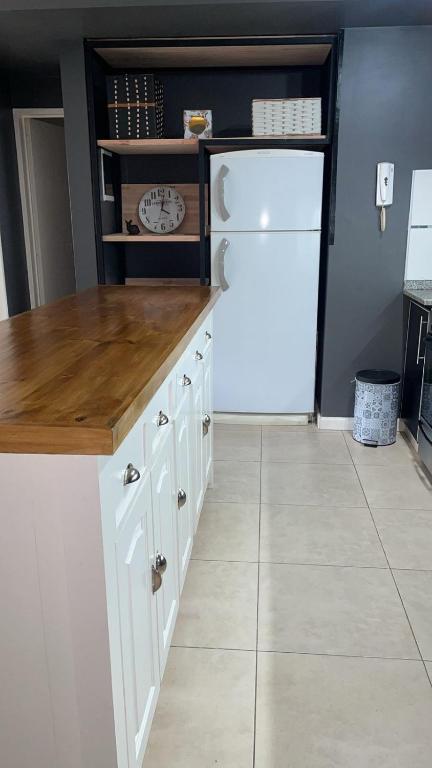 a kitchen with white cabinets and a white refrigerator at Ballester city in Villa Ballester