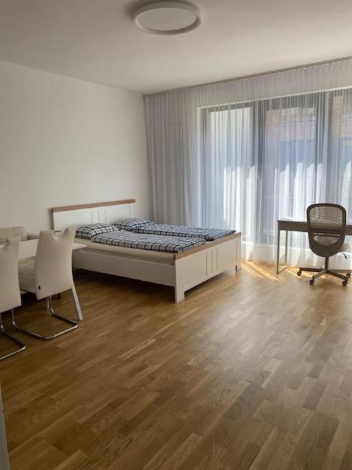 a bedroom with a bed and a desk and chairs at Quiet apartment near Prague centre in Prague
