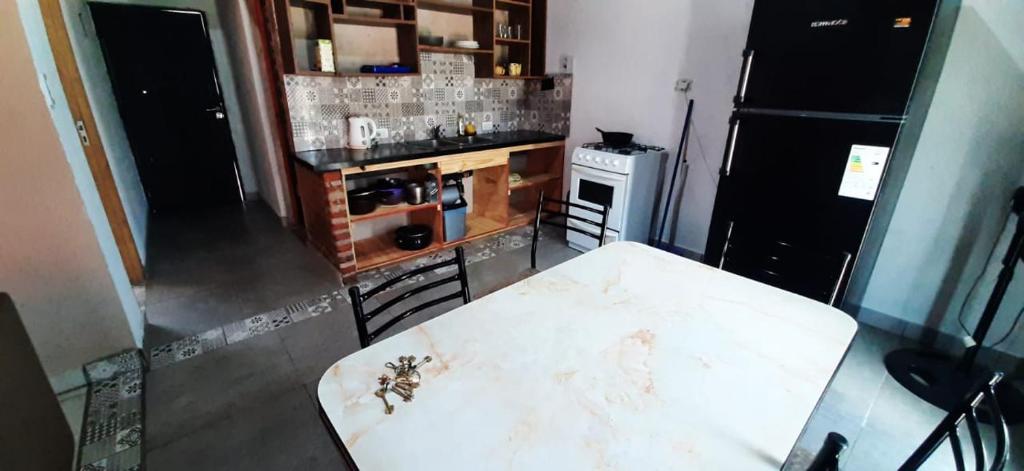 a kitchen with a white counter top and a table at DiversidadMDP in Mar del Plata