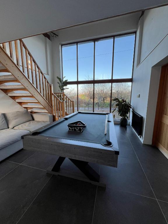 a living room with a pool table in the middle at Oak Barn-ideal for Nec,Hs2,BHX,family gatherings in Birmingham