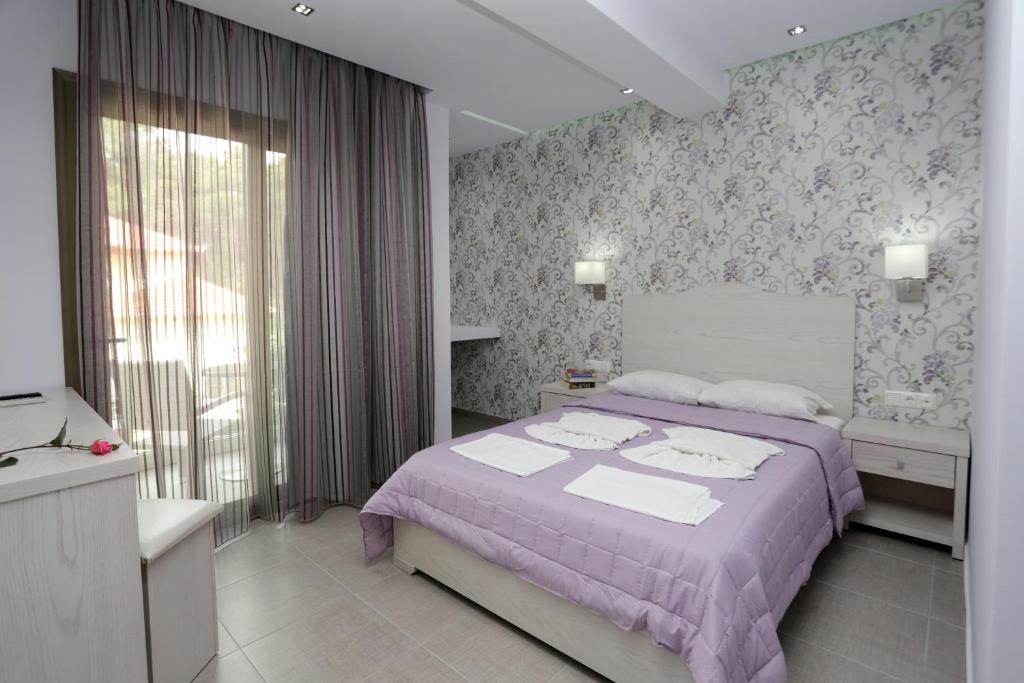 Postel nebo postele na pokoji v ubytování Hotel Akti