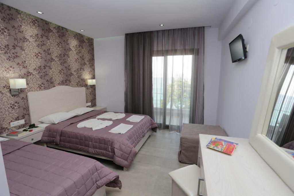 Postel nebo postele na pokoji v ubytování Hotel Akti