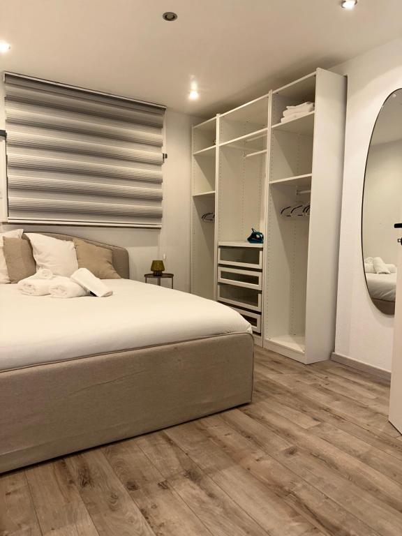 ein Schlafzimmer mit einem Bett und einem großen Spiegel in der Unterkunft logement indépendant proche Colmar parking wifi in Wintzenheim