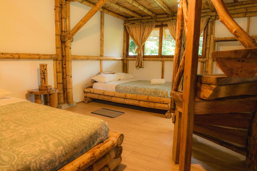 Postel nebo postele na pokoji v ubytování Finca Las Palmas Ecolodge