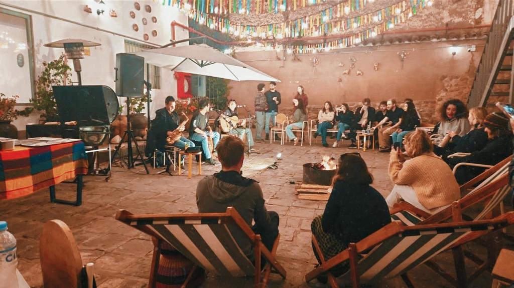 a group of people sitting in chairs watching a presentation at Viajero Cusco Hostel in Cusco