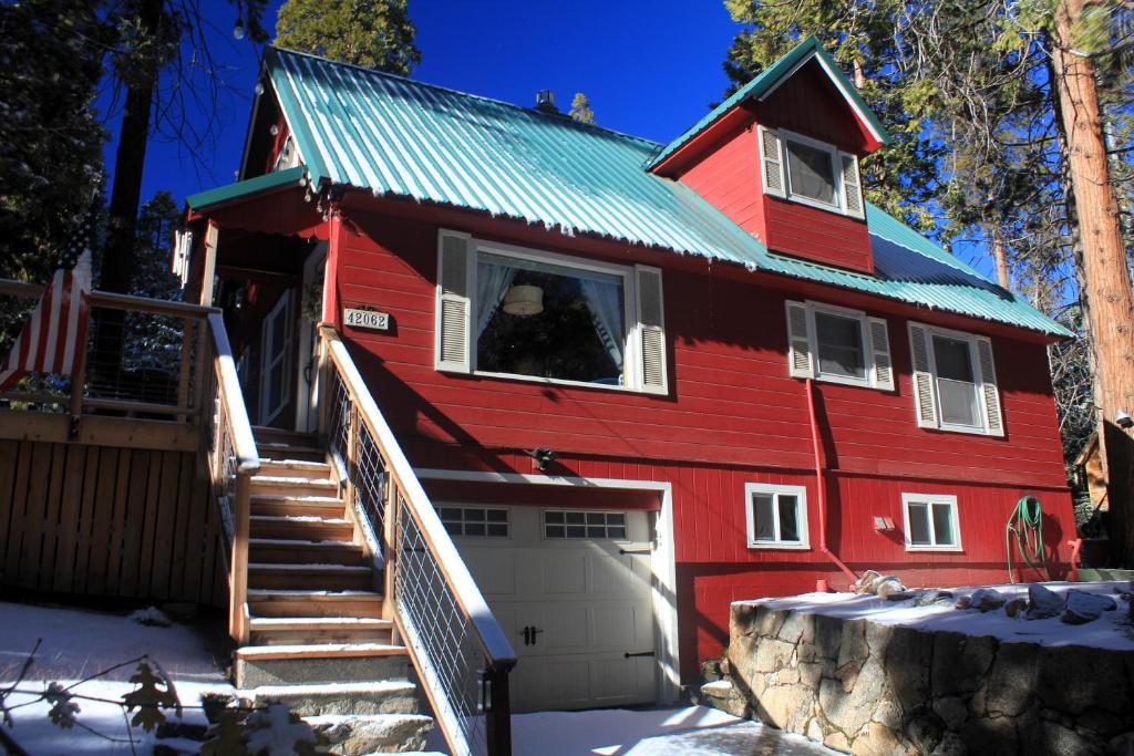 a red house with a man looking out of a window at Elliott House Boutique Inn in Shaver Lake