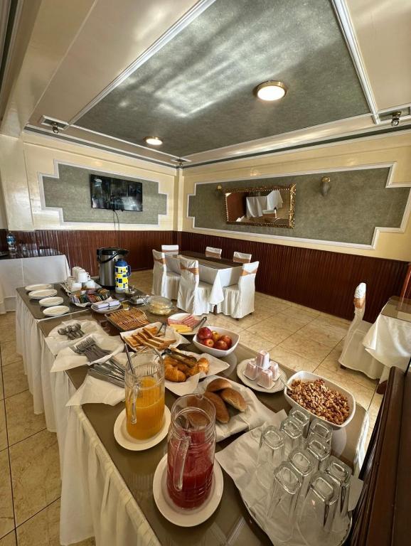 a long table with plates of food on it at Galax Resort in Oruro