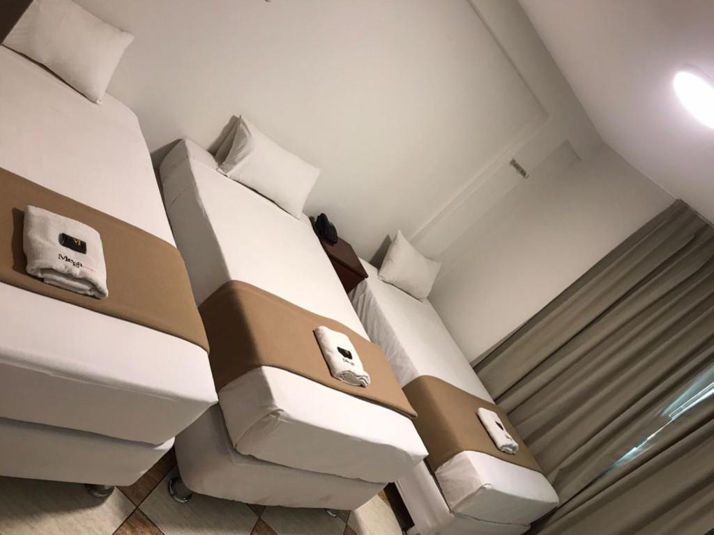 Postel nebo postele na pokoji v ubytování Hotel Mega