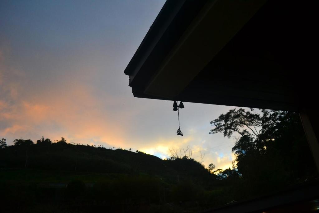 a view of the sunset with a pair of shoes dangling at Zhong Ming Ju Taoyi Fang in Fanlu