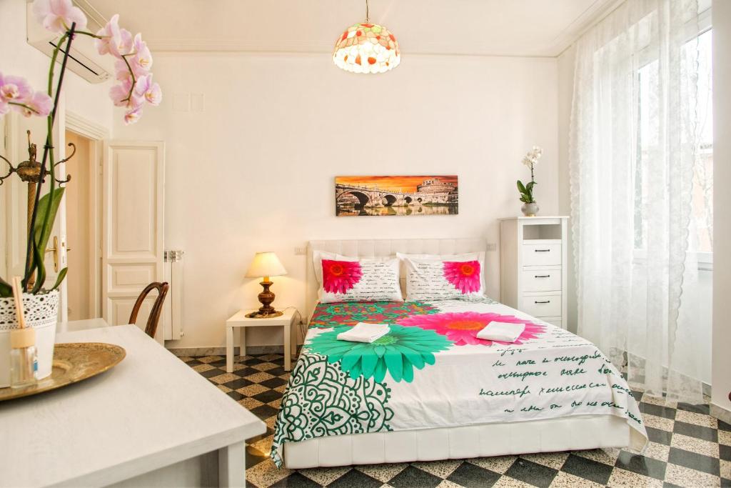 a bedroom with a bed with pink and green at Vatica B&B Roma in Rome
