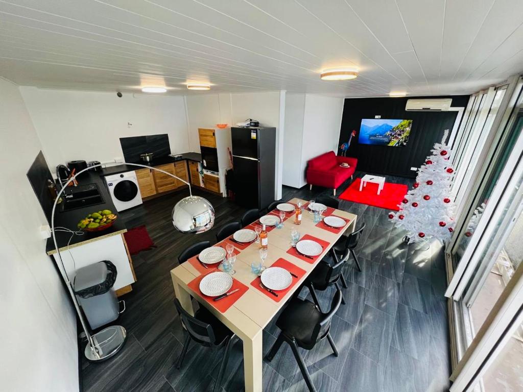 a room with a table and a christmas tree at Tahiti Sunshine in Papeete