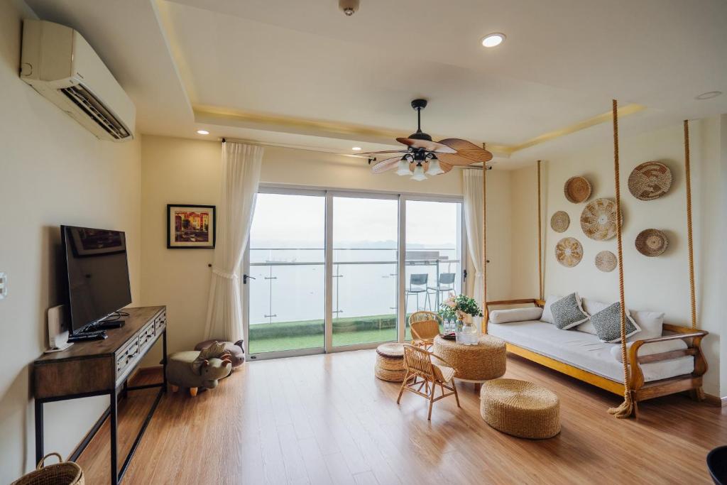 a living room with a couch and a large window at Mian Sapphire Home toà S1 S2 in Ha Long