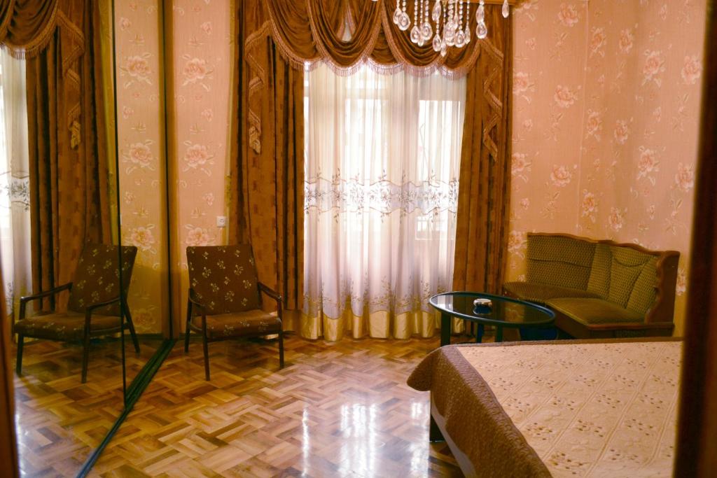 a room with a window with chairs and a table at Nova Lux Apartments in Tbilisi City