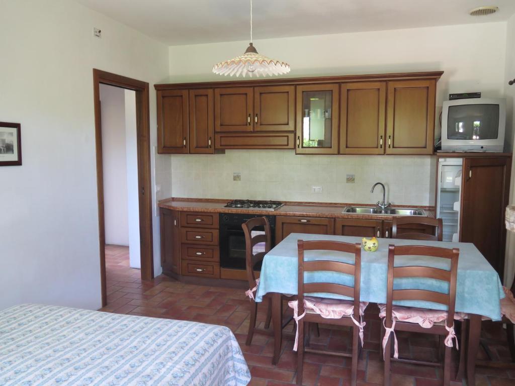 a kitchen with a table and chairs and a sink at Tenuta Lio Maggiore in Lido di Jesolo