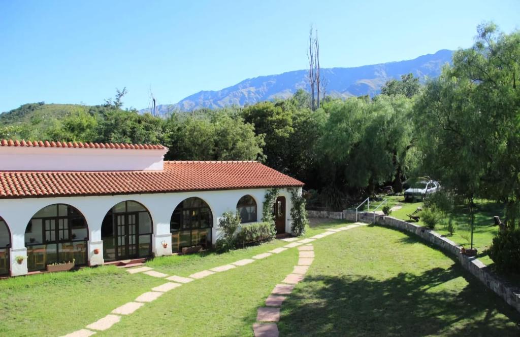 a building with a grassy yard next to a house at Posada del Virrey in Pantanillo