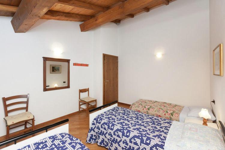 A bed or beds in a room at Podere Montestuccioli