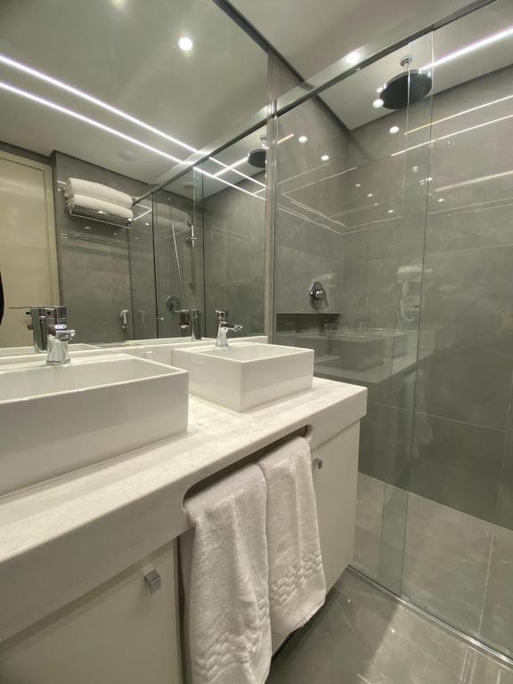 a bathroom with two sinks and a large mirror at Ninety Stay Premium in Sao Paulo