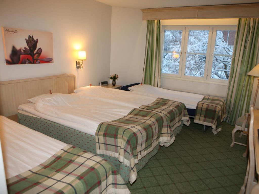 Postel nebo postele na pokoji v ubytování Hotel Mölndals Bro
