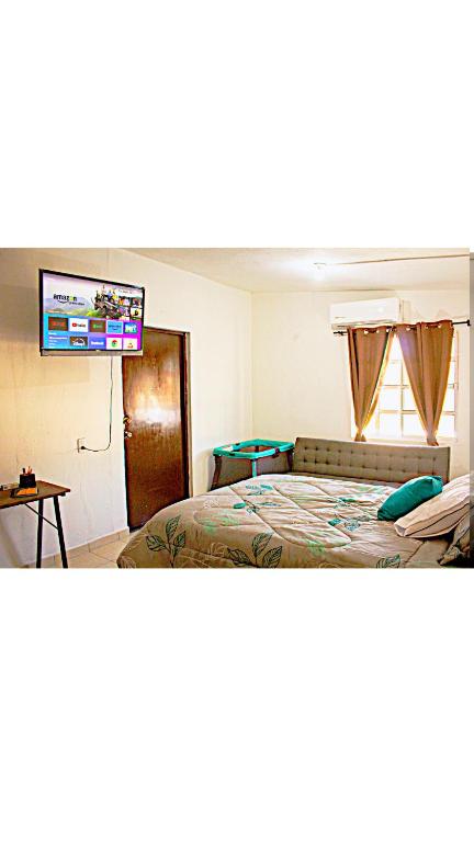a bedroom with a bed and a flat screen tv at Depto 1 equipado x mitras cerca a imss 25 y a pasos del metro in Monterrey