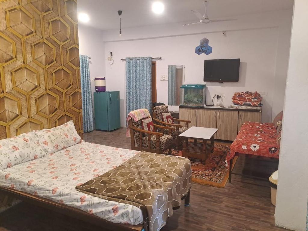 a living room with a couch and a tv at Tirupati home stay in Ujjain