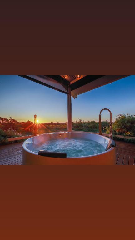 a hot tub with a view of the sunset at Love at Sellicks Chills in Sellicks Hill