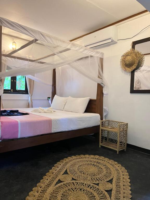 a bedroom with a bed with a canopy at Jungle Nook Hiriketiya in Hiriketiya