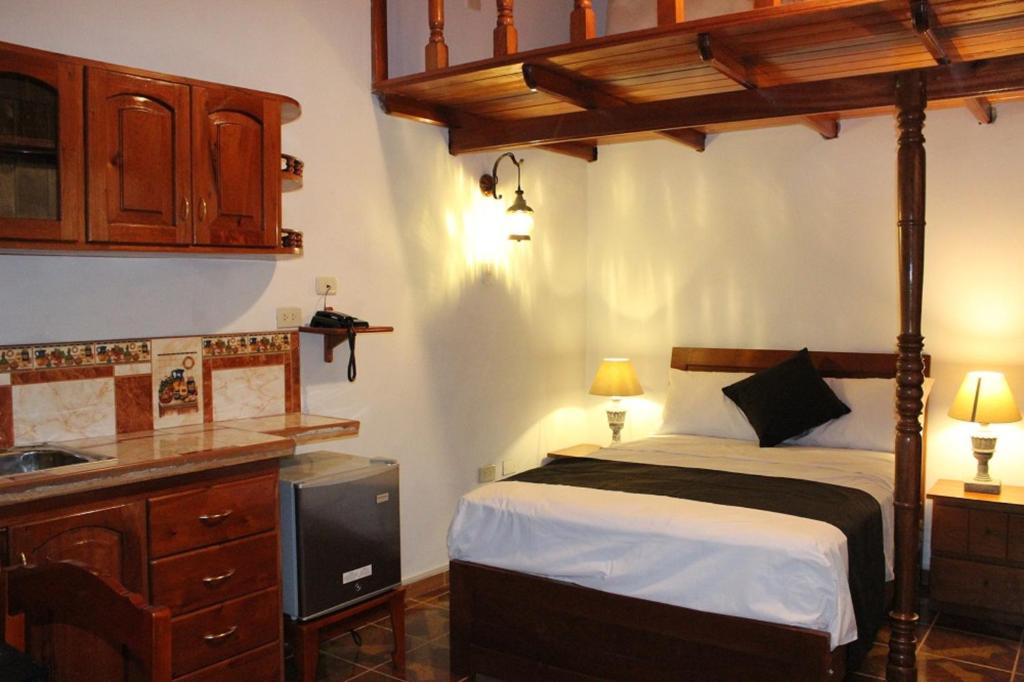 a bedroom with a bed and a sink in it at Epoca Iquitos in Iquitos