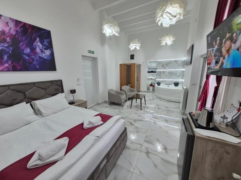 a bedroom with a large bed and a bathroom at 15 PERCENT OFF UNTIL 31st OF AUGUST ABC Luxury Space with 7 suites for 15 Guests - One Suite with Hot Tub and Sauna, Paid Parking on-site, Mandatory Reservation in Belgrade