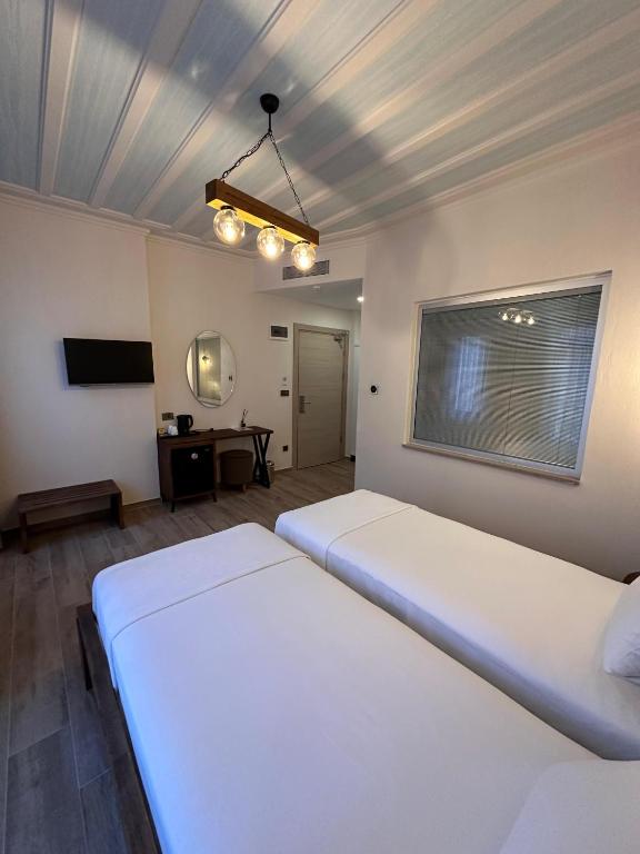 Postel nebo postele na pokoji v ubytování Cunda Nisa Otel