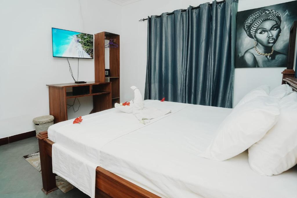 Postel nebo postele na pokoji v ubytování Tamu House Pajé Beach