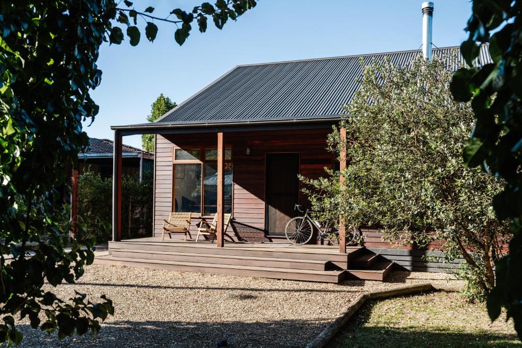 a house with a wooden porch with a bike on it at The Wooden House in Bright