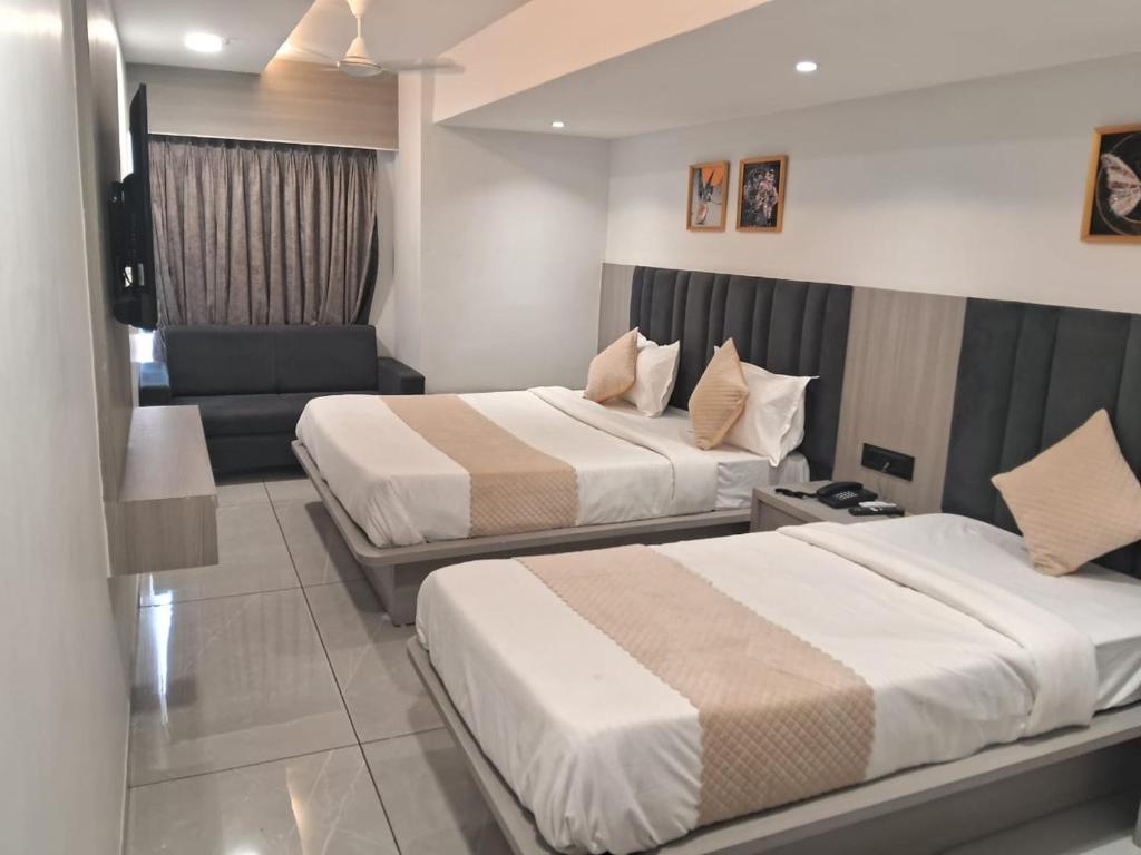 Postel nebo postele na pokoji v ubytování Hotel Metro Inn