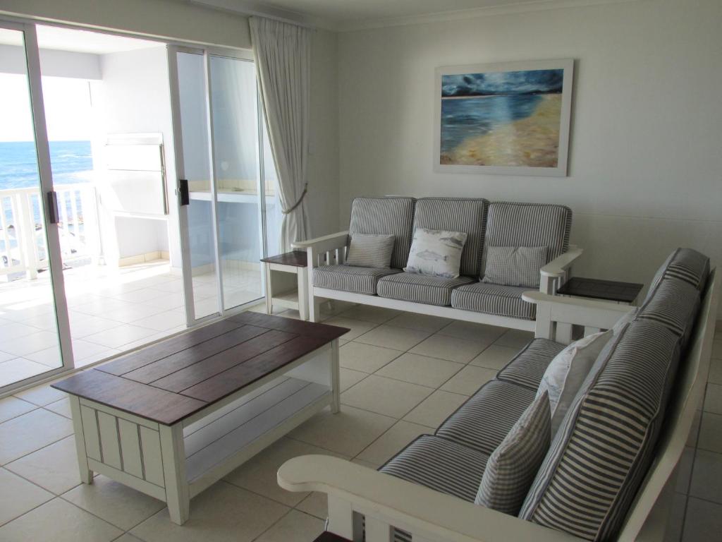a living room with a couch and a table at Point Village Accommodation - Linda in Mossel Bay