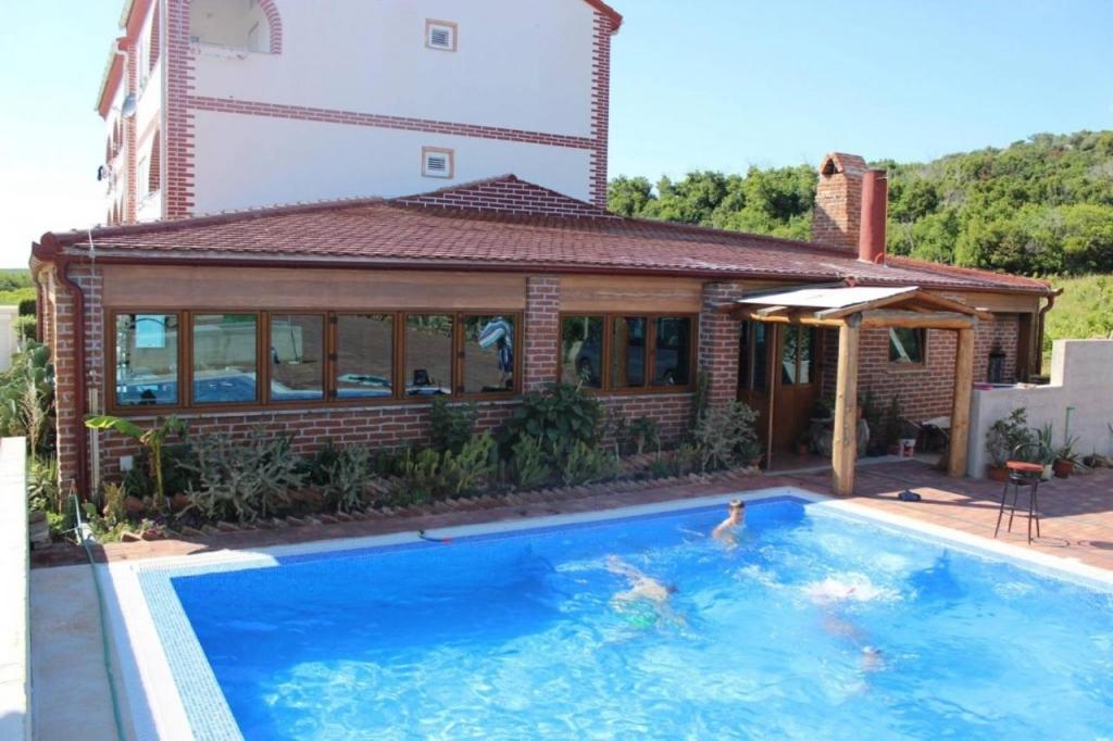 a swimming pool in front of a house at Apartment in Novalja with sea view, terrace, air conditioning, WiFi 3565-1 in Novalja