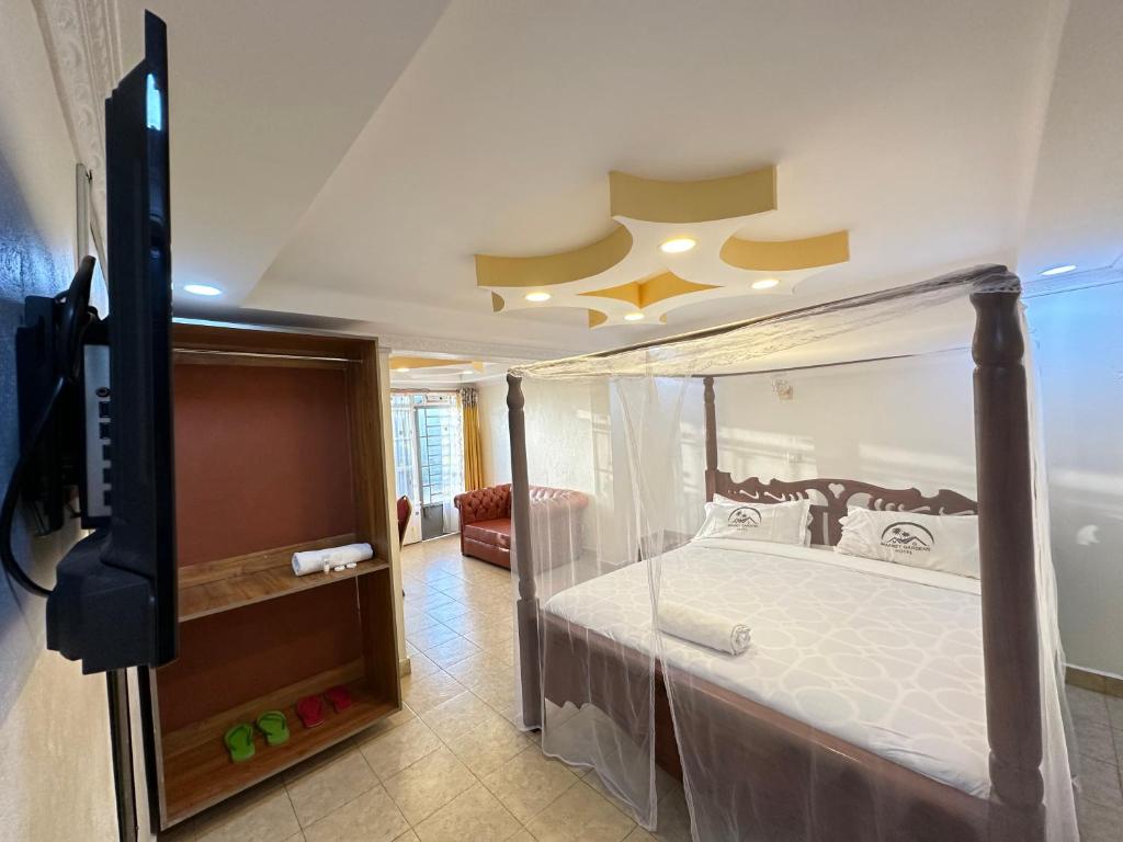 Postel nebo postele na pokoji v ubytování Maanet Gardens Hotel