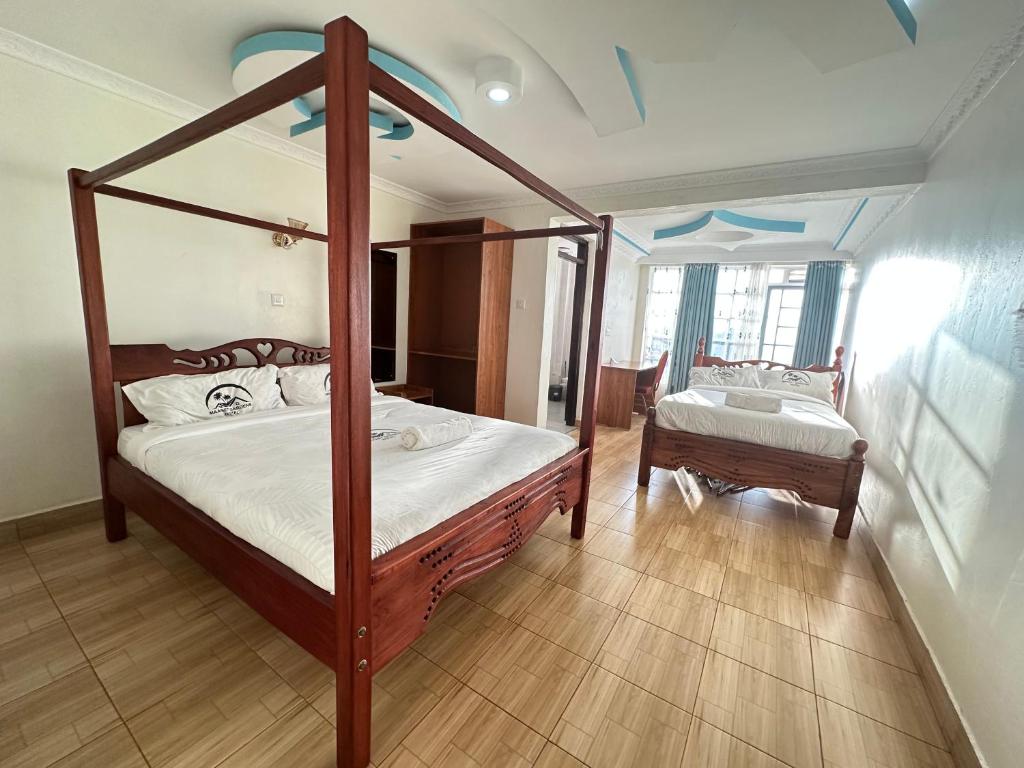 Postel nebo postele na pokoji v ubytování Maanet Gardens Hotel