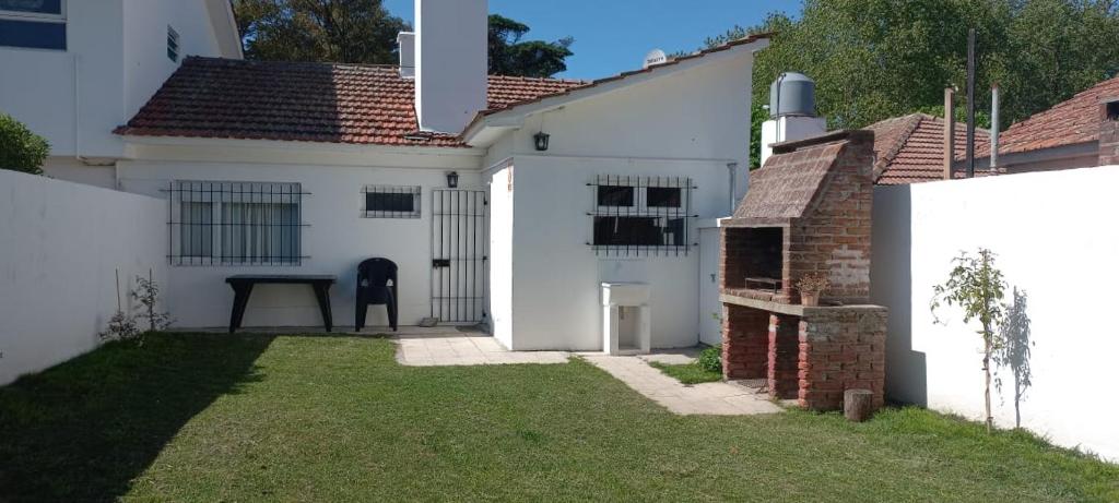 a white house with a yard in front of it at La Mary in Mar del Plata