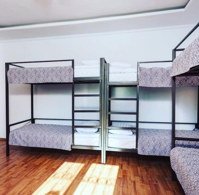 a room with four bunk beds in a room at Достык Хостел in Almaty