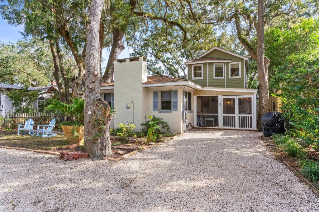 a small house with a tree in the driveway at Sea Lyon Around - 1134 Park in East End