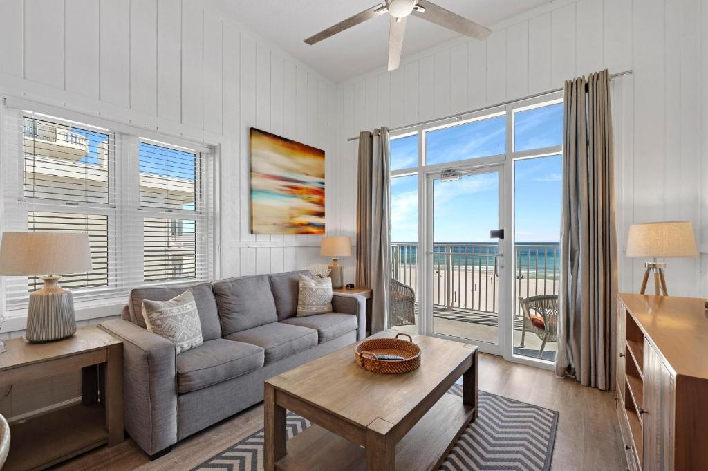 a living room with a couch and a view of the ocean at Windemere 301 in Perdido Key