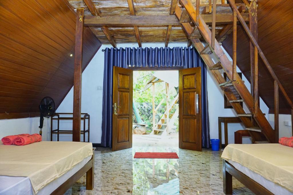 Postel nebo postele na pokoji v ubytování Sigiri Sky Home & TreeHouse