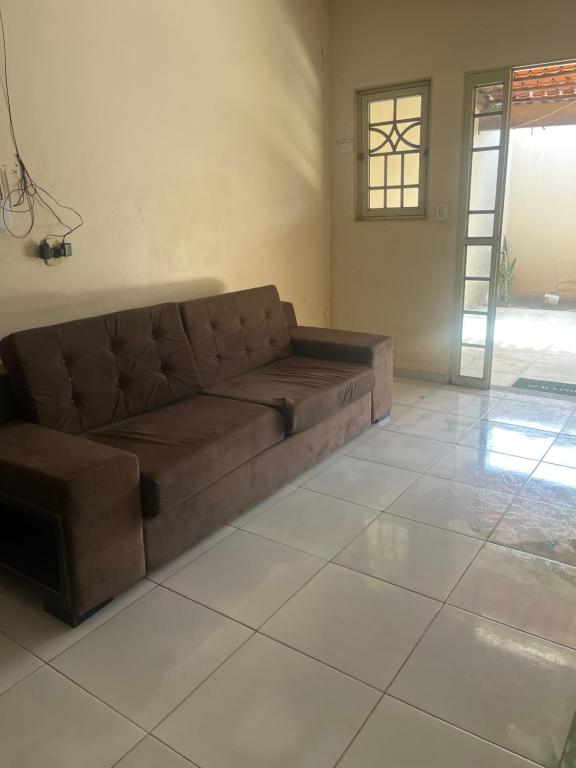 a brown couch sitting in a living room at Araujo in Governador Valadares