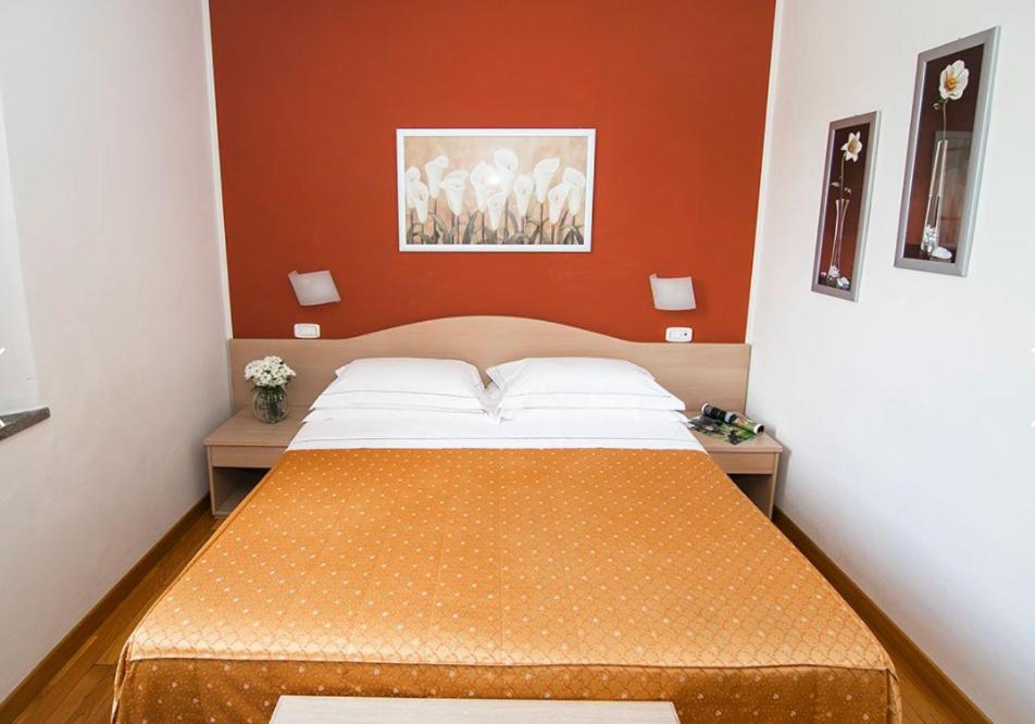 Postel nebo postele na pokoji v ubytování Hotel La Colonna