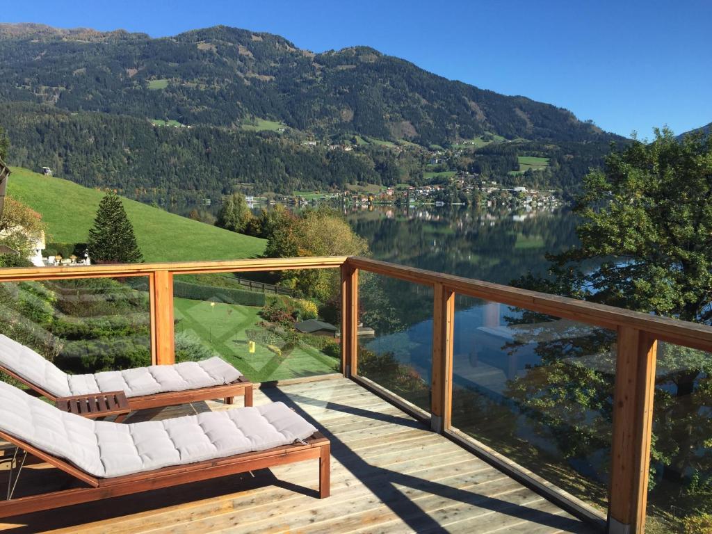 a balcony with a view of a lake and mountains at Seehaus Weiss in Rothenthurn