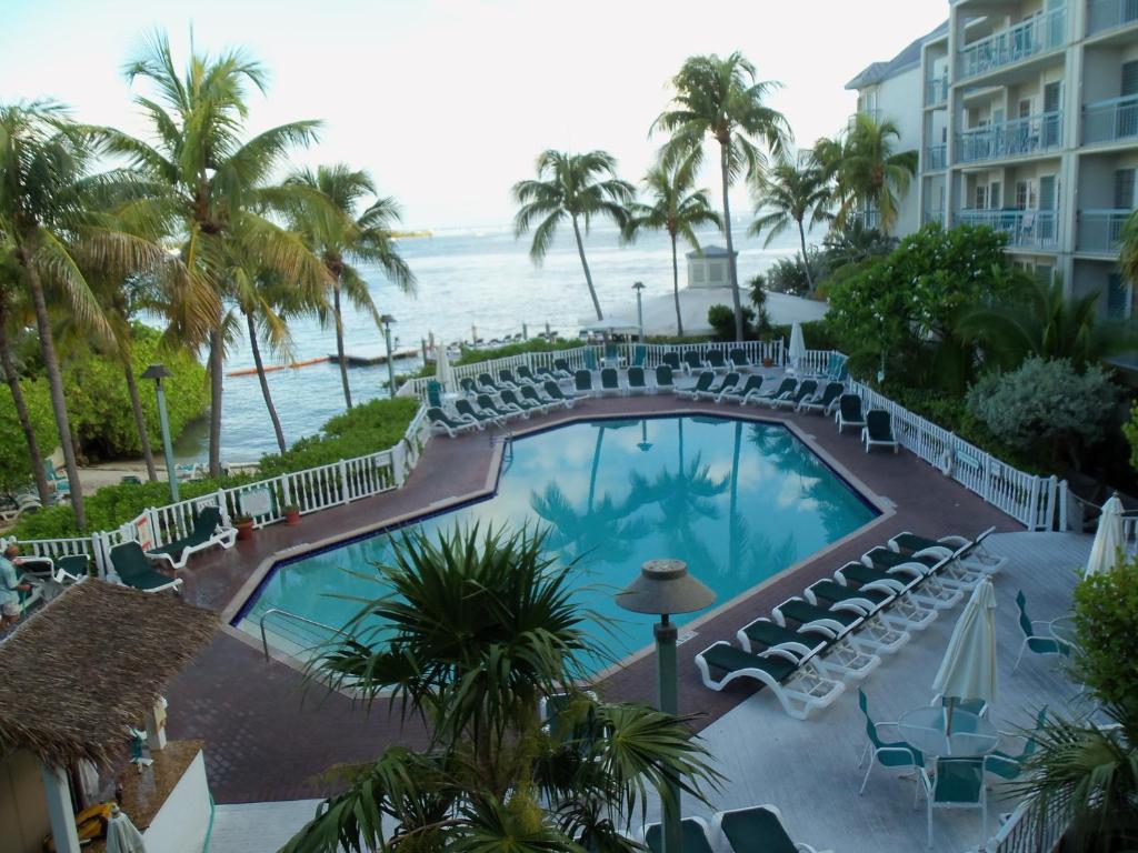 a view from the balcony of a hotel with a pool and the ocean at Galleon Resort and Marina in Key West