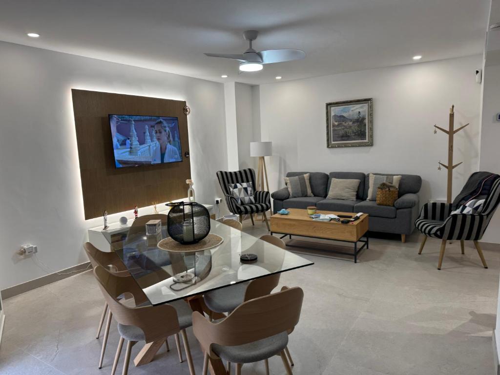 a living room with a table and chairs and a couch at Cabosun in El Cabo de Gata