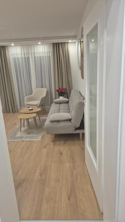 a living room with a couch and a table at Bella Vacanza Apartment in Banja Luka
